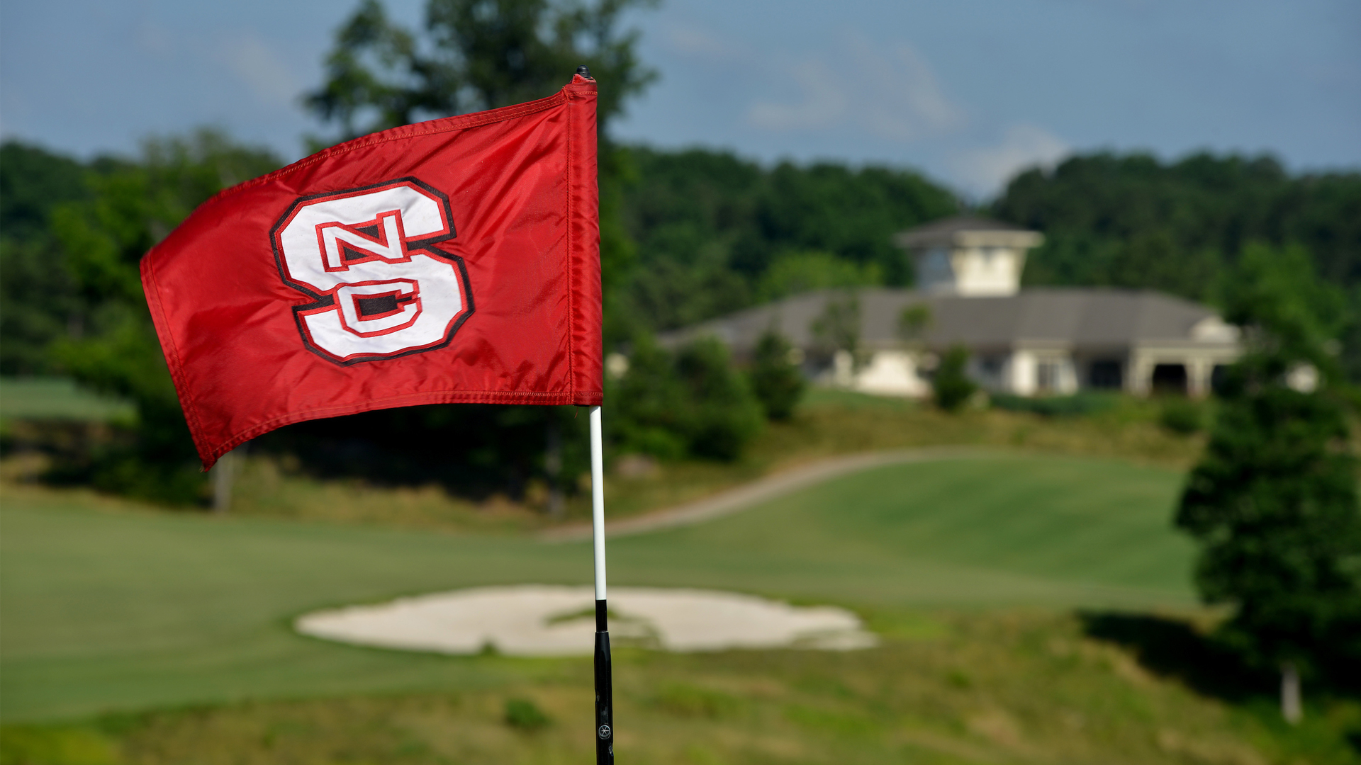 An NC State flag blows in the wind on the Lonnie Poole Golf Course.