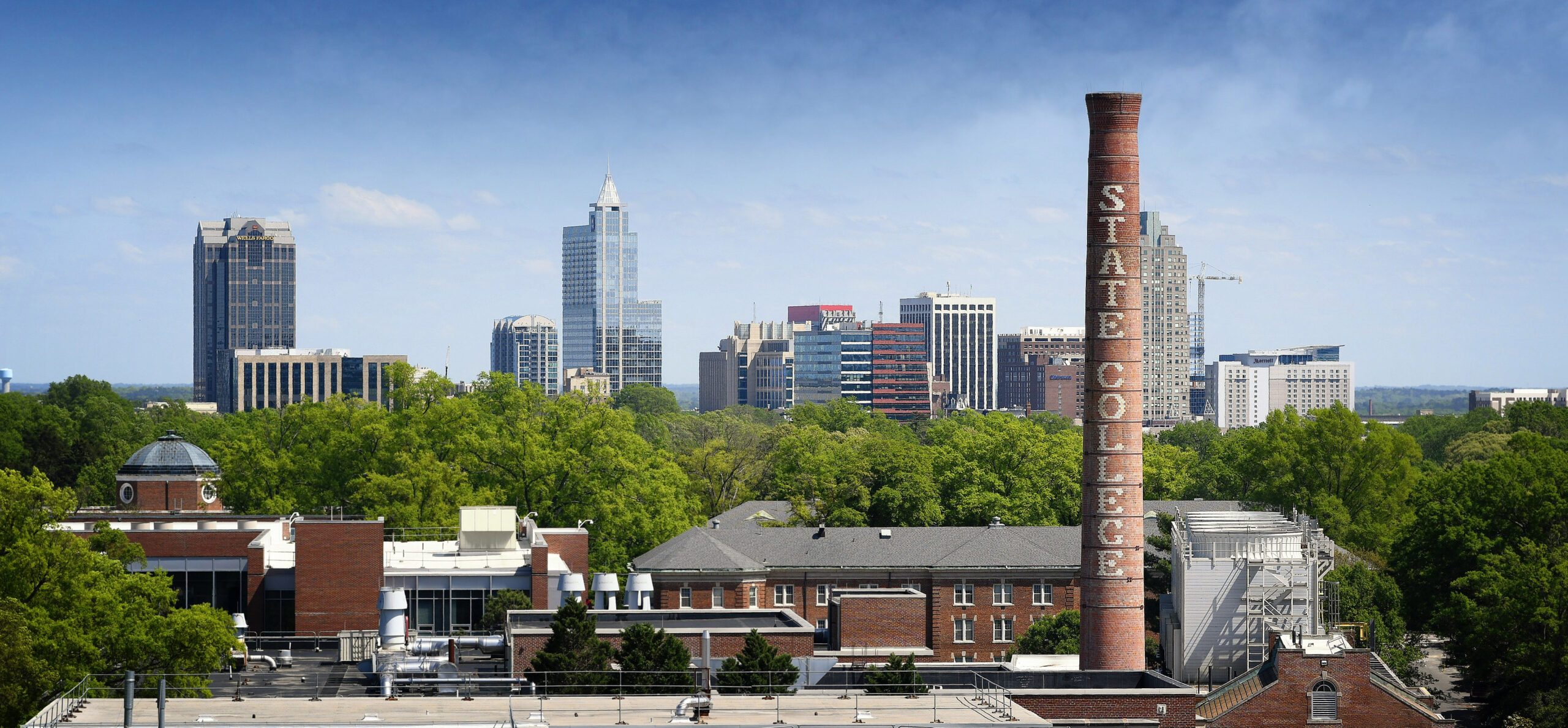 Downtown Raleigh skyline, framed by the State College smoke stack.