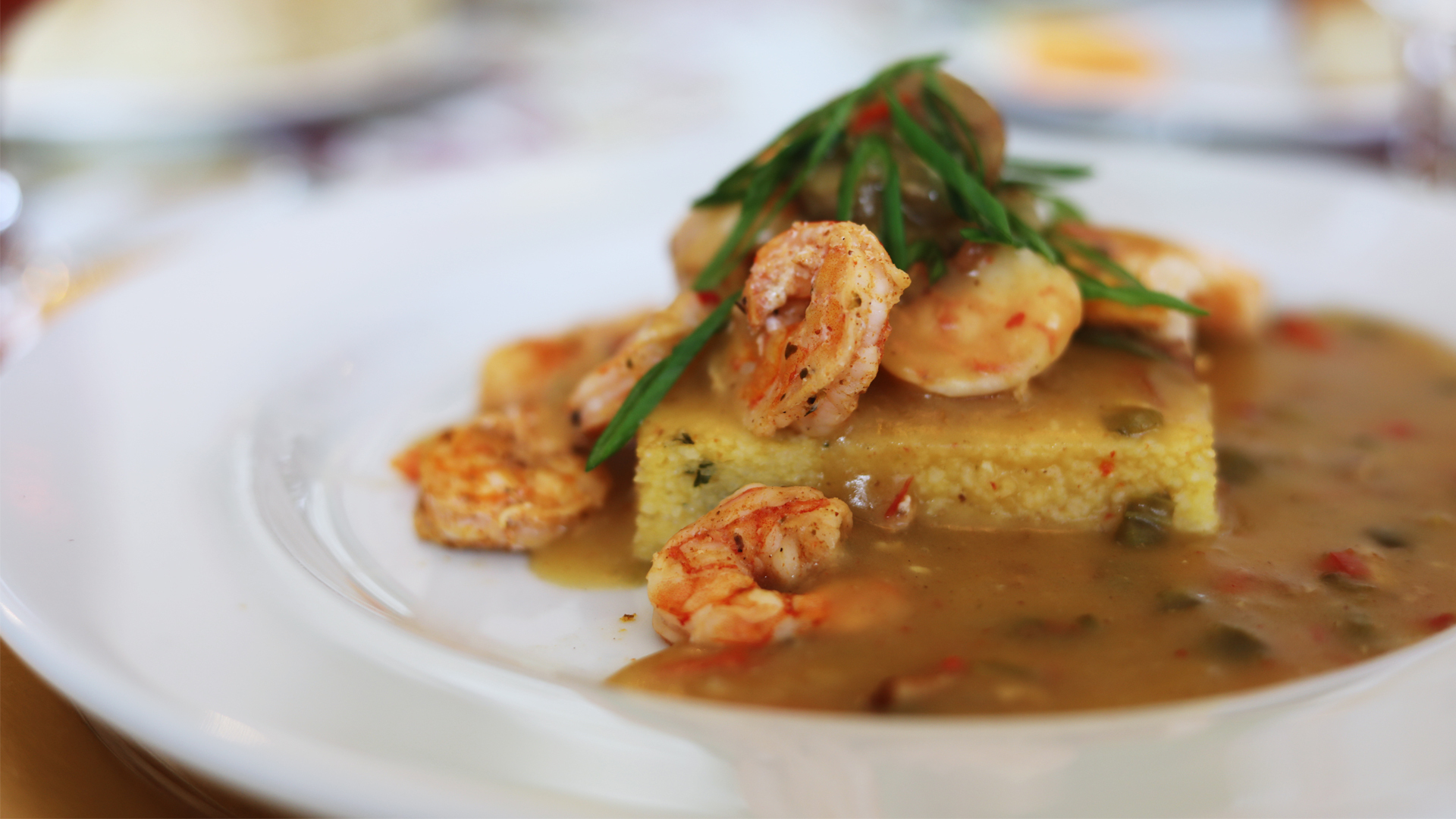 A plate of shrimp served with cornbread from Rave! Events catering.